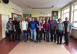 Uczestnicy rajdu pozują do zdjęcia przed kącikiem patrona szkoły