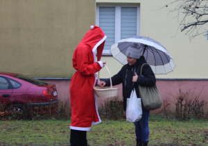 Mikołaj częstuje słodyczami mieszkańców osiedla Michałówek